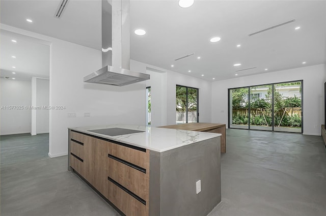 kitchen featuring black electric cooktop, a center island, light stone countertops, and island range hood