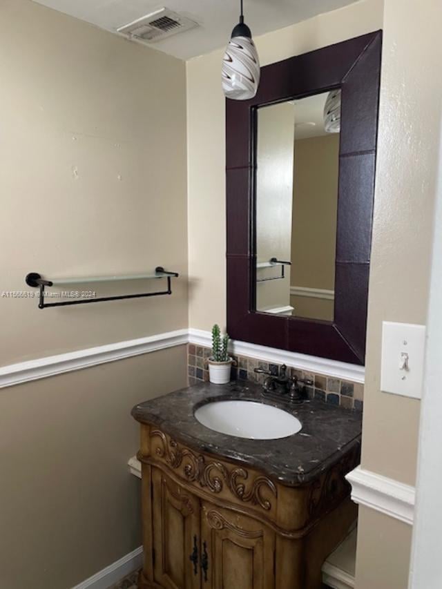 bathroom featuring tasteful backsplash and vanity