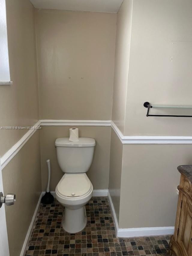 bathroom with vanity, tile floors, and toilet