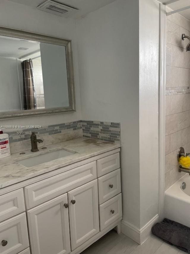 bathroom featuring vanity and bathing tub / shower combination