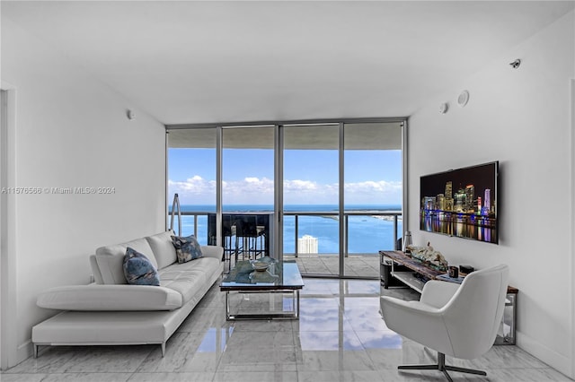 living room with floor to ceiling windows, a water view, and light tile flooring