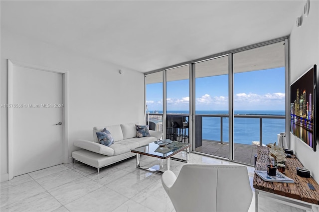 tiled living room featuring a water view and floor to ceiling windows