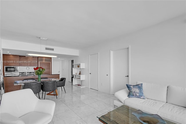 living room featuring sink and light tile floors