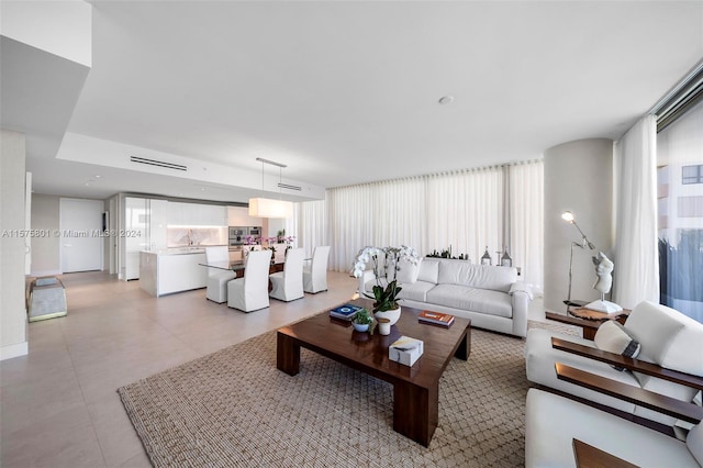 tiled living room featuring sink