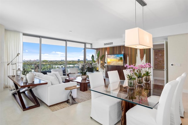 dining room with floor to ceiling windows and light tile floors