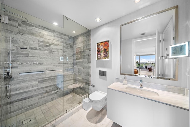 bathroom featuring walk in shower, tile floors, vanity with extensive cabinet space, and toilet