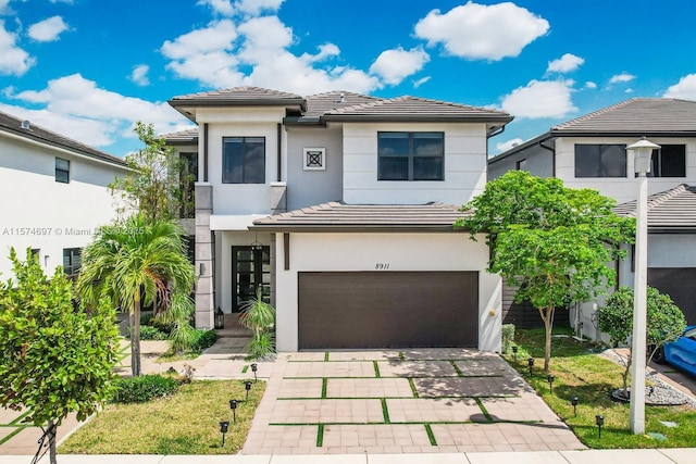 view of front of property featuring a front yard and a garage