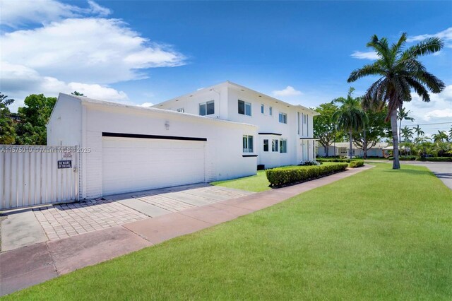 view of front of property with a garage and a front yard