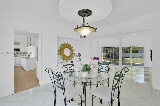 dining area with light tile patterned floors and ornamental molding