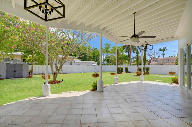 view of patio featuring ceiling fan and a shed