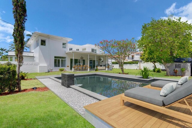 view of swimming pool featuring an outdoor living space, a patio area, a yard, and a storage unit