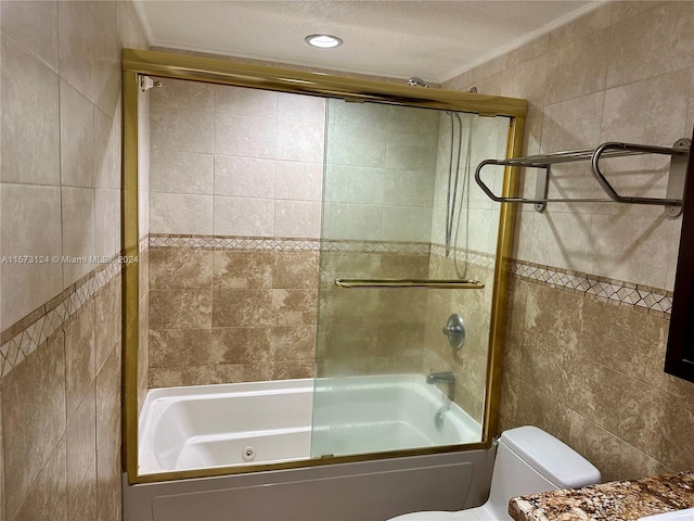 bathroom featuring shower / bath combination with glass door, a textured ceiling, toilet, and tile walls