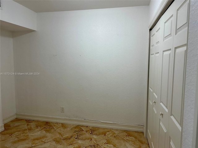 unfurnished room with light tile floors