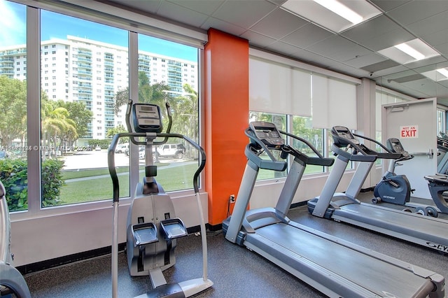 exercise room with a paneled ceiling