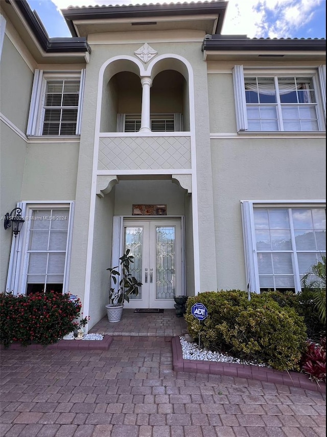 entrance to property with french doors and a balcony