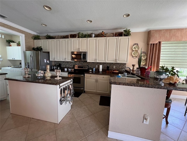 kitchen featuring light tile floors, sink, tasteful backsplash, stainless steel appliances, and ornamental molding