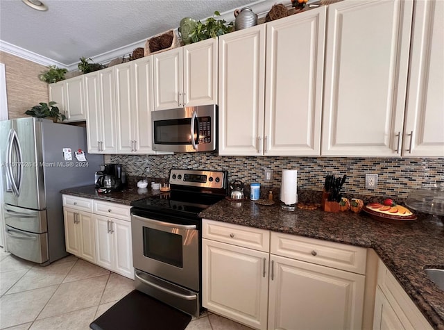 kitchen with ornamental molding, tasteful backsplash, and appliances with stainless steel finishes