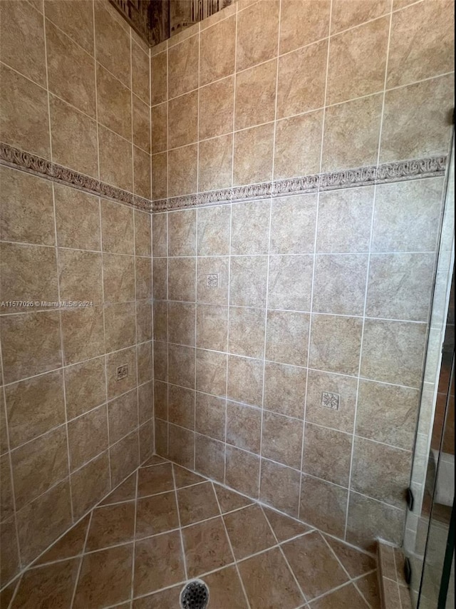 bathroom with a tile shower