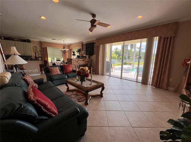 living room with ceiling fan, light tile floors, and a stone fireplace