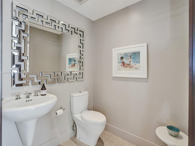 bathroom with tile patterned floors and toilet