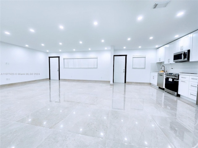 basement with sink and light tile flooring