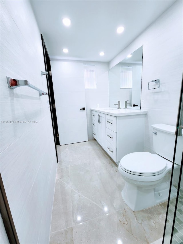 bathroom with large vanity, tile floors, and toilet