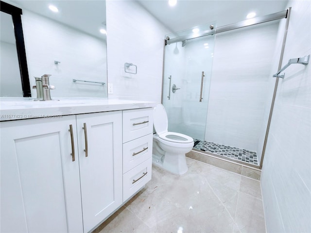 bathroom with tile floors, vanity with extensive cabinet space, an enclosed shower, and toilet