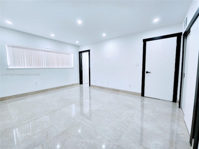 unfurnished room with light tile flooring