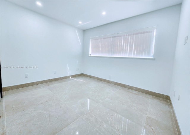 spare room with light tile floors