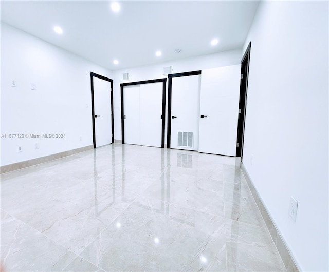 unfurnished room with light tile floors