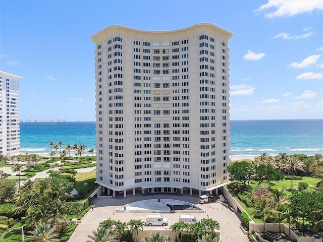 view of property featuring a view of the beach and a water view