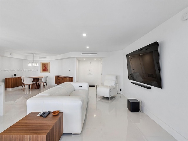 tiled living room with a notable chandelier