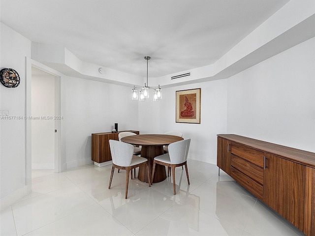 dining space featuring an inviting chandelier and light tile patterned flooring