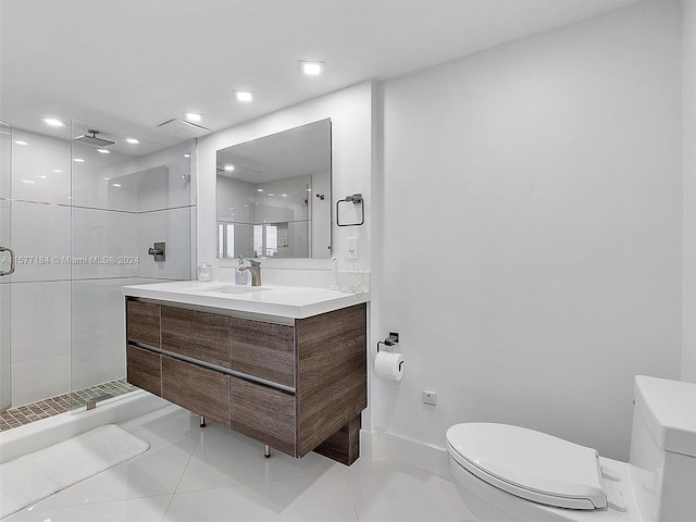 bathroom featuring vanity, toilet, walk in shower, and tile patterned floors