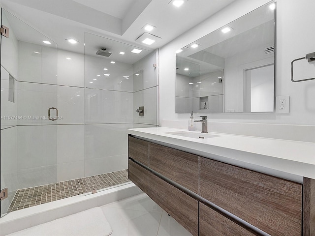 bathroom featuring vanity and a shower with shower door