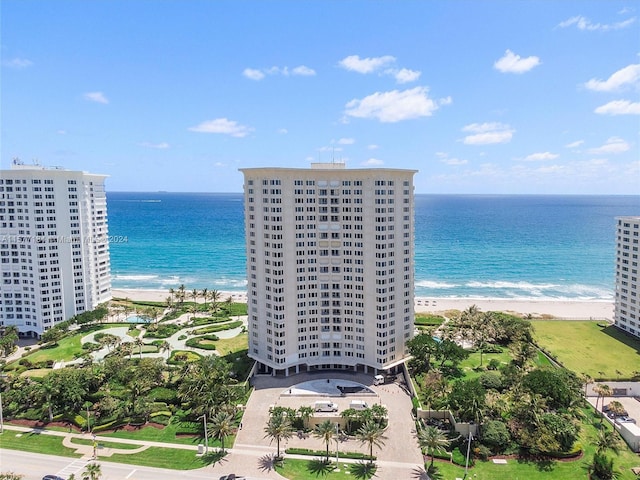 bird's eye view with a water view and a beach view