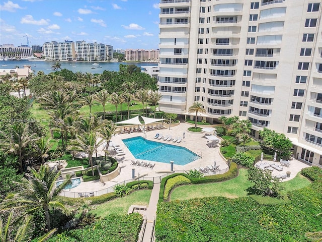 view of swimming pool with a water view and a patio