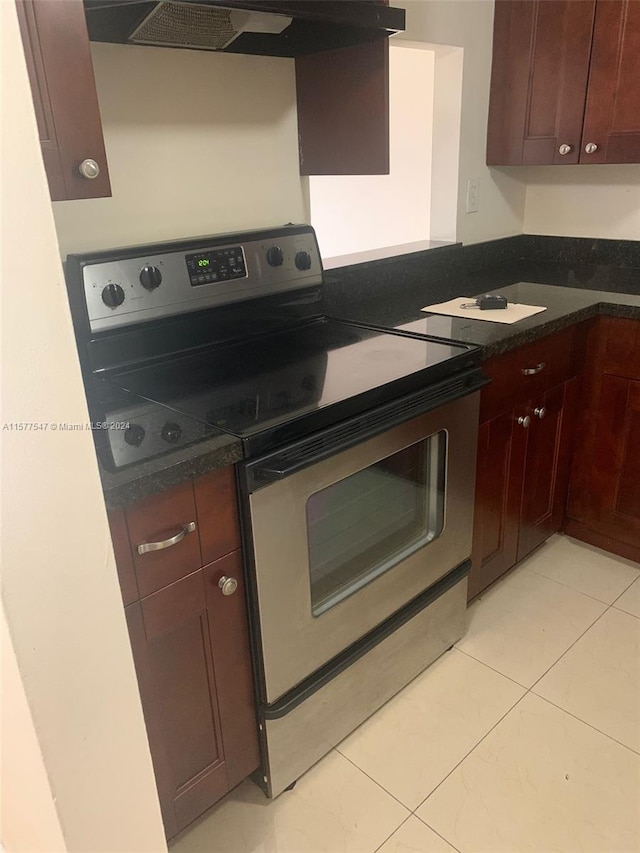 kitchen with stainless steel range with electric cooktop, light tile floors, and extractor fan