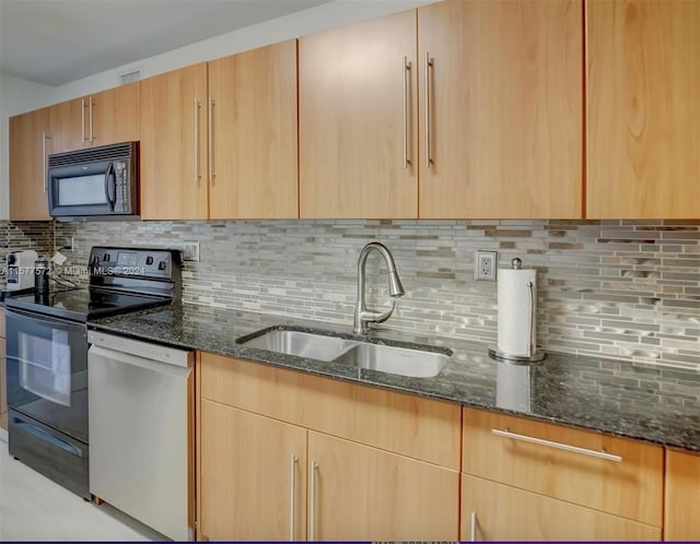 kitchen featuring dark stone countertops, tasteful backsplash, and black appliances