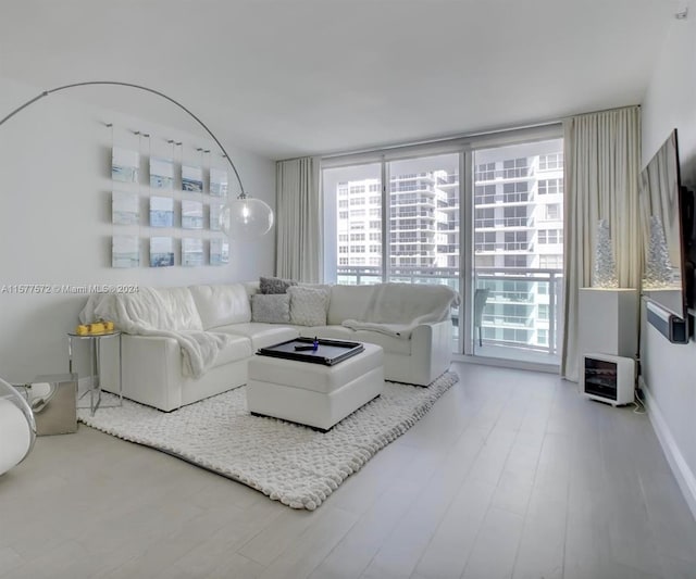 living room with a healthy amount of sunlight and hardwood / wood-style flooring