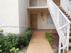 view of exterior entry with a balcony