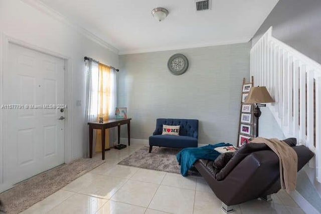 living area featuring crown molding and light tile patterned floors