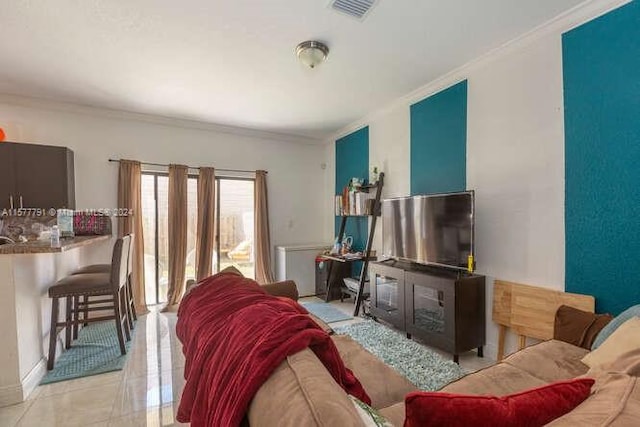 living room with crown molding and light tile patterned floors