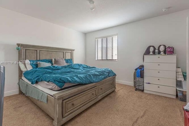 bedroom featuring light carpet