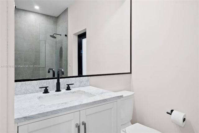 bathroom with vanity, an enclosed shower, and toilet