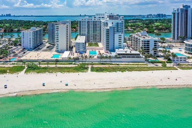 drone / aerial view featuring a water view and a beach view