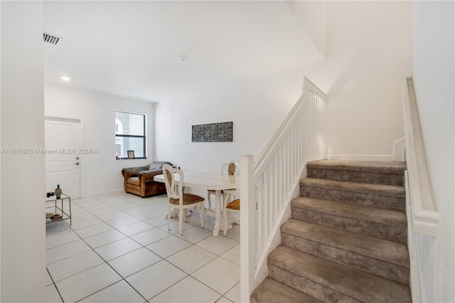 staircase featuring tile patterned floors