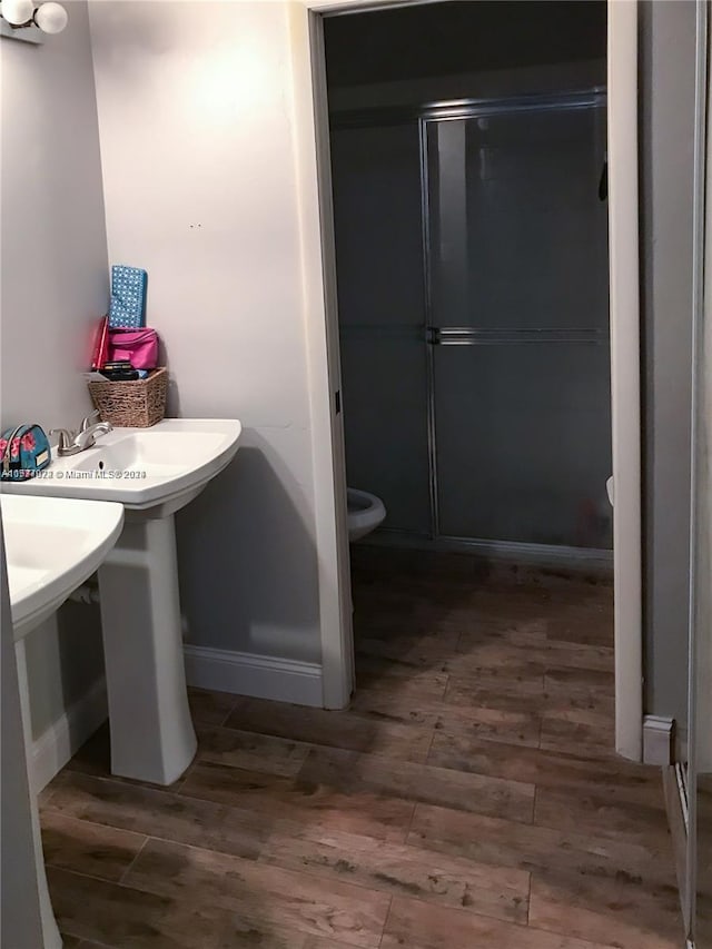 bathroom featuring hardwood / wood-style floors and toilet