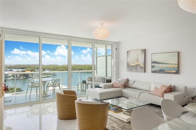 living room with a water view, expansive windows, and light tile flooring