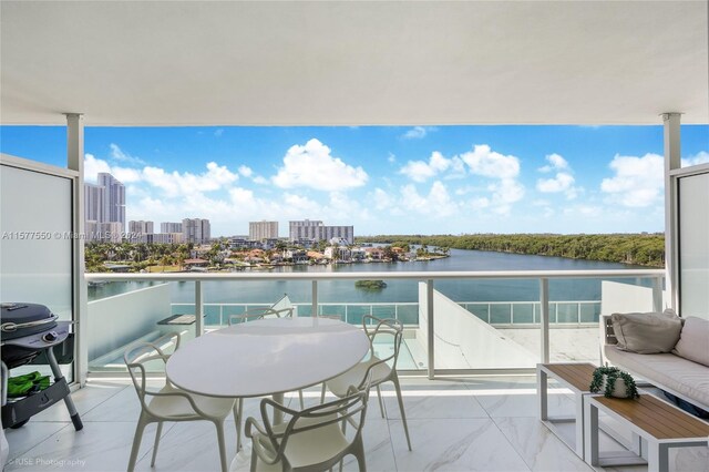 balcony with a water view and area for grilling